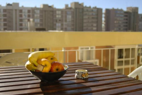 a bowl of fruit sitting on a wooden table on a balcony at Apartments with WiFi Split - 11312 in Split