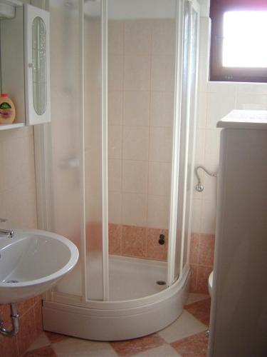 a bathroom with a shower and a sink at Apartments by the sea Maslinica, Solta - 11422 in Grohote
