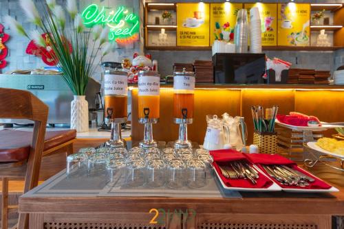 a table with glasses and drinks on a table at 22Land Hotel & Residence in Hanoi