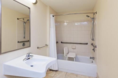 a bathroom with a sink and a tub and a toilet at Staybridge Suites San Antonio Downtown Convention Center by IHG in San Antonio