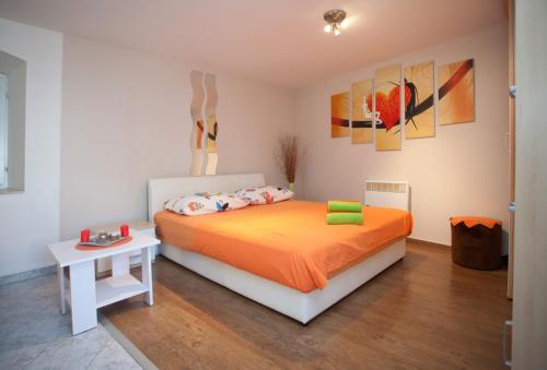 a bedroom with a bed and a table in it at Apartments by the sea Split - 11161 in Split