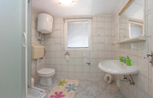 a white bathroom with a toilet and a sink at Apartments by the sea Split - 11161 in Split