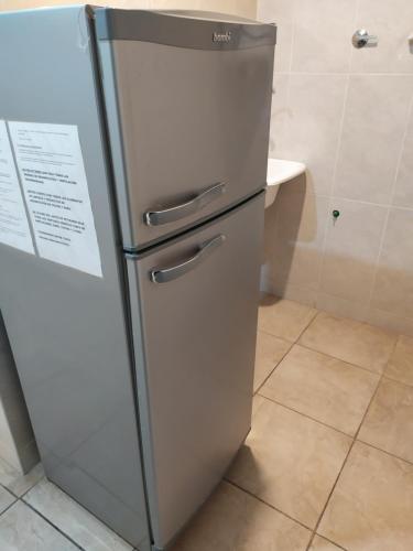 a stainless steel refrigerator in a kitchen at Infinity lounge apartment, lujoso, céntrico y amplio in San Rafael