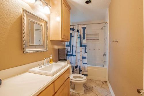 a bathroom with a sink and a toilet and a shower at Huge 6 Bedroom with Pool, Spa, 85 Inch TV, Game Room in Houston