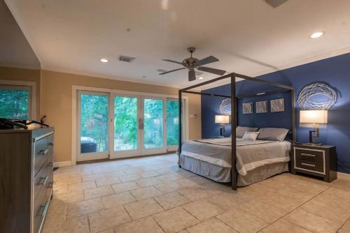 a bedroom with a bed and a ceiling fan at Huge 6 Bedroom with Pool, Spa, 85 Inch TV, Game Room in Houston