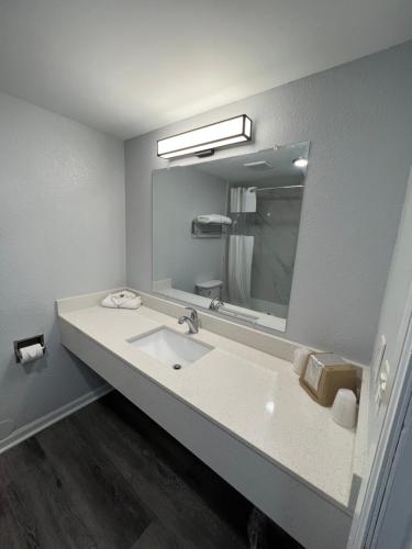 a bathroom with a sink and a large mirror at Motel 6 - Franklin, OH in Franklin