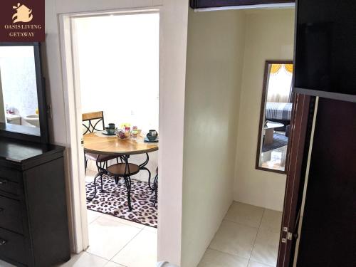 a dining room with a table and a mirror at Oasis Living Getaway in Mandeville, Manchester in Mandeville