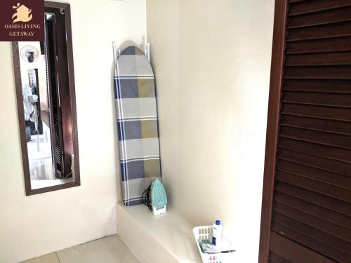 a bathroom with a surfboard on a wall at Oasis Living Getaway in Mandeville, Manchester in Mandeville