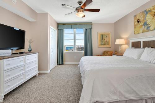a bedroom with a bed and a flat screen tv at Vitamin Sea - Modern Beach Highrise At Ocean Walk Resort Daytona Beach in Daytona Beach