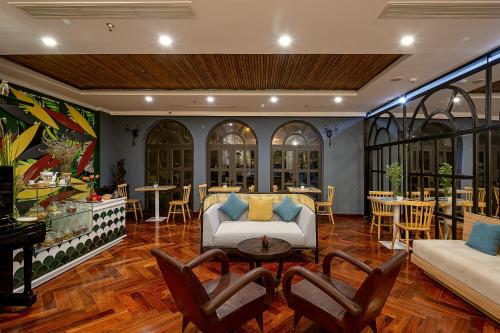 a living room with a couch and a table at Le House Boutique Hotel - 100m to the beach in Da Nang