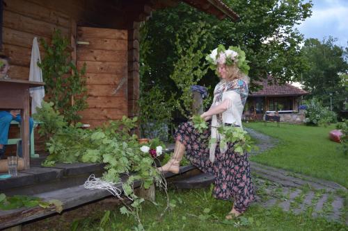 a woman sitting on the steps of a house at Mīlmaņi in Ranka