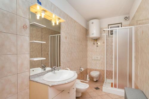 a bathroom with a sink and a toilet at Apartments with a parking space Zambratija, Umag - 2533 in Savudrija