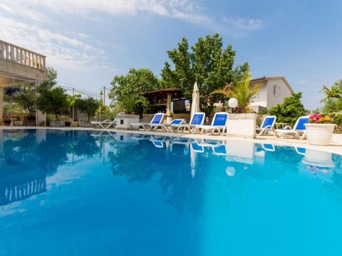 einen Pool mit Liegestühlen und blauem Wasser in der Unterkunft Villa Stil in Trogir