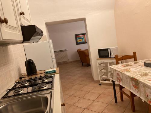 a kitchen with a stove and a refrigerator at Poncinvs Residence in Bergamo
