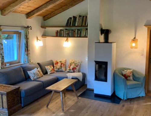 a living room with a couch and a fireplace at Zuhaus Schernfeichten in Kitzbühel