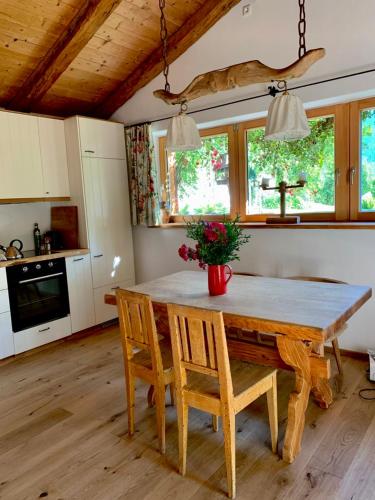 a kitchen with a large wooden table and chairs at Zuhaus Schernfeichten in Kitzbühel