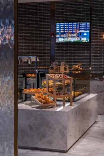 a bakery with many different types of pastries on display at Harbour Plaza Metropolitan Shanghai in Shanghai