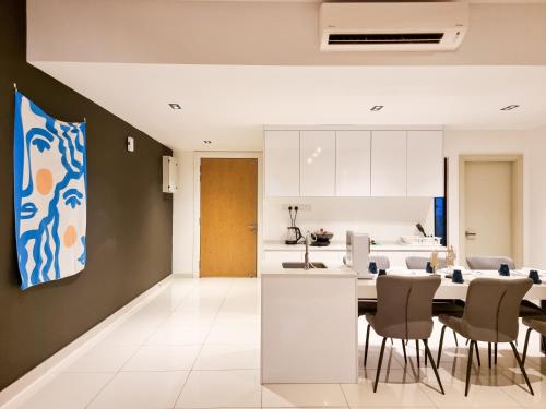 a kitchen and dining room with a table and chairs at Midvalley Southkey Mosaic Suite by Nest Home in Johor Bahru
