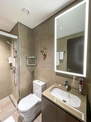 a bathroom with a toilet and a sink and a mirror at STAY BY LATINEM Luxury 2BR Holiday Home CV B2513 near Burj Khalifa in Dubai