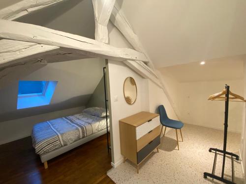 a bedroom with a bed and a desk in a room at Le doyenne in Nevers