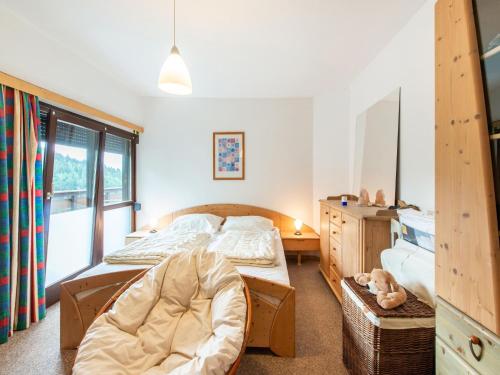 a bedroom with two beds and a chair in it at Apartment in Tauplitz with sauna and pool in Tauplitz