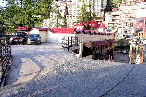 a street with a building in the middle of a city at Royale Retreat Hotel & Spa Near Mall Road in Shimla