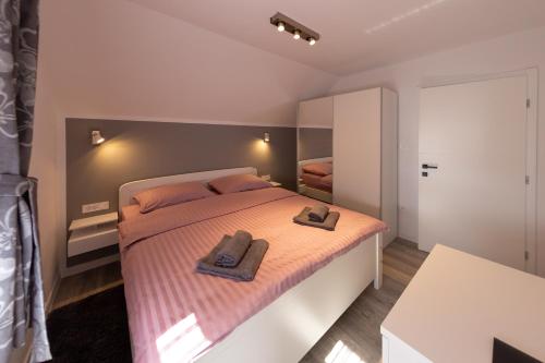 - une chambre avec un lit et 2 serviettes dans l'établissement Apartments River, à Otočac