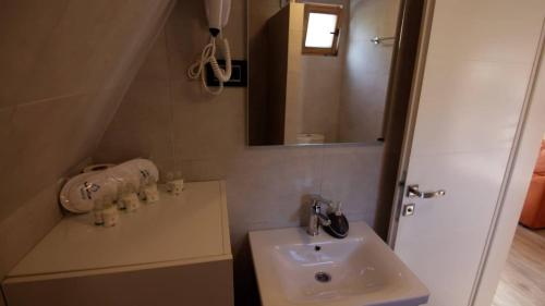 a bathroom with a sink and a mirror at Apartmani Relax in Višegrad