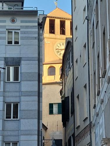 a clock tower in the middle of a city at PIAZZETTA la MADDALENA 2 in Savona