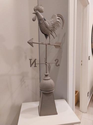 a statue of a rooster on a scale at PIAZZETTA la MADDALENA 2 in Savona