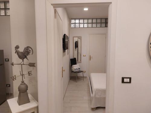 a hallway with a chicken ornament on the wall and a desk at PIAZZETTA la MADDALENA 2 in Savona