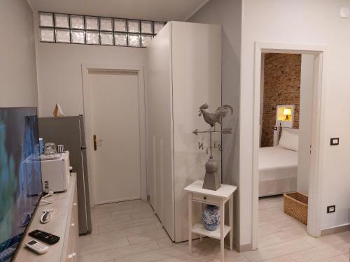 a room with a room with a bed and a room with a kitchen at PIAZZETTA la MADDALENA 2 in Savona