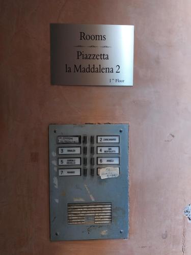 an old metal box with a sign on a wall at PIAZZETTA la MADDALENA 2 in Savona