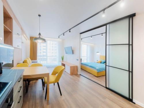 a room with a kitchen and a bedroom with a bed at Сучасні апартаменти в новобудові in Lviv