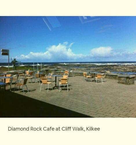 a group of chairs and tables on the beach at Luxurious Property, Paddy's Haven, Wild Atlantic Way, County Clare in Kilrush