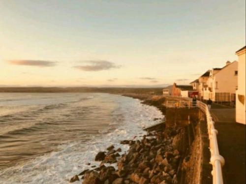 a view of the ocean with houses and rocks at Luxurious Property, Paddy's Haven, Wild Atlantic Way, County Clare in Kilrush