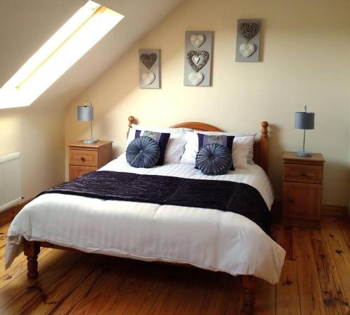 a bedroom with a large bed with pillows on it at Luxurious Property, Paddy's Haven, Wild Atlantic Way, County Clare in Kilrush