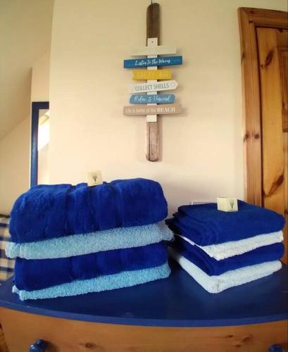 three blue towels sitting on top of a blue table at Luxurious Property, Paddy's Haven, Wild Atlantic Way, County Clare in Kilrush