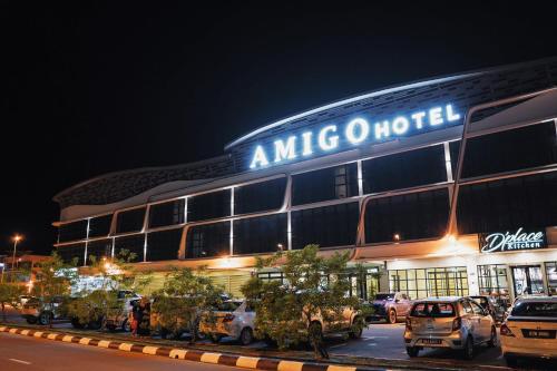 a amico hotel at night with cars parked in front at Amigo Hotel Bintulu in Bintulu
