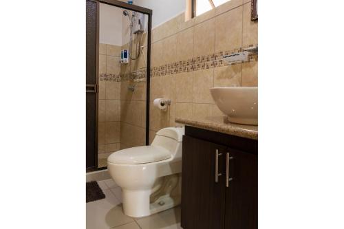 een badkamer met een toilet en een wastafel bij Aptos Casa Caribe, habitaciones privadas en aptos compartidos & aptos completos con auto entrada in Puerto Limón