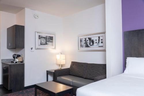 a hotel room with a bed and a couch at Holiday Inn Express & Suites Columbus - Polaris, an IHG Hotel in Columbus