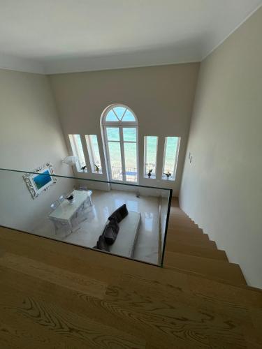a living room with a glass window and a couch at Luxury Loft on the Sea in Trapani