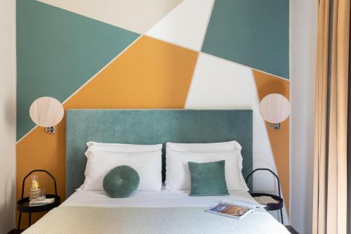 a bedroom with a bed with a colorful headboard at Boutique Hotel Galatea in Rome