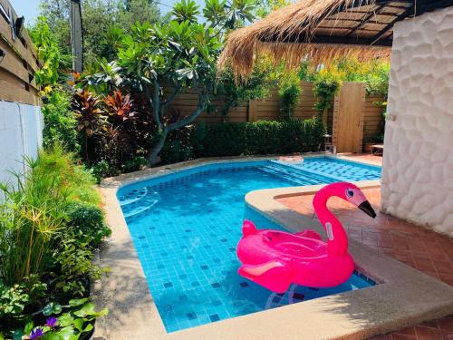 a pink plastic swan in a swimming pool at BTC Boutique Resort Private Pool Villas and Studios Hua Hin บ้านทะเลจีน บูติค รีสอร์ท หัวหิน in Hua Hin