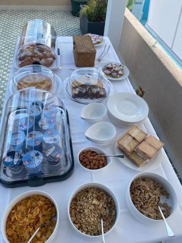 a table with different types of food on it at NoOne Tropea Guesthouse in Tropea