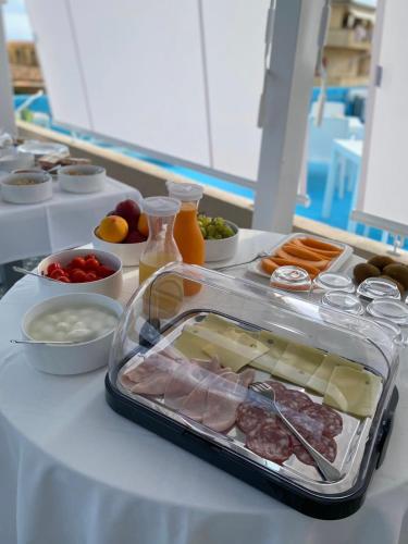 a table with a tray of meat and other foods at NoOne Tropea Guesthouse in Tropea