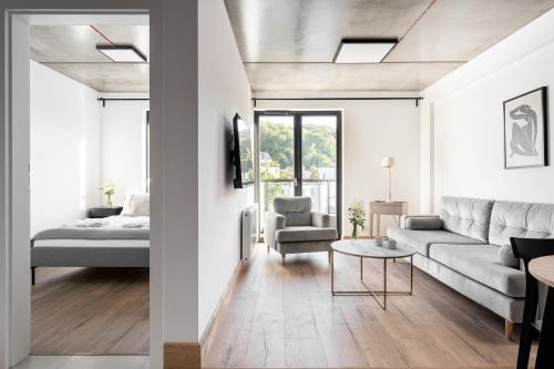 a living room with a couch and a table at Apartamenty Przystanek Morska in Gdynia