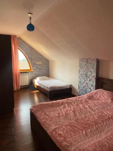 a hotel room with two beds and a window at Amadeus in Bakuriani