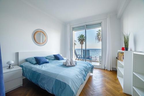 a bedroom with a bed with a view of the ocean at Bel Appartement Face à La Mer Près Du Centre - Le Voilier in Cannes