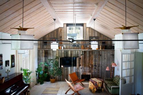 a living room with wood paneled walls and a television at Bakgården i Revsund in Gällö